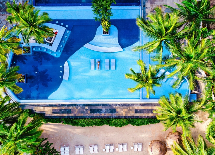 Overhead view of the pool surrounded by palm trees at The Sens Cancun